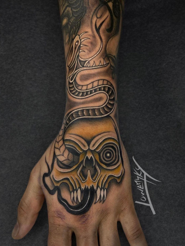 Hand and forearm tattoo in black and grey fine line with yellow  of a snake coming out of a skull tattooed by Sacred Mandala's Lowensky Santiago in Durahm, NC.